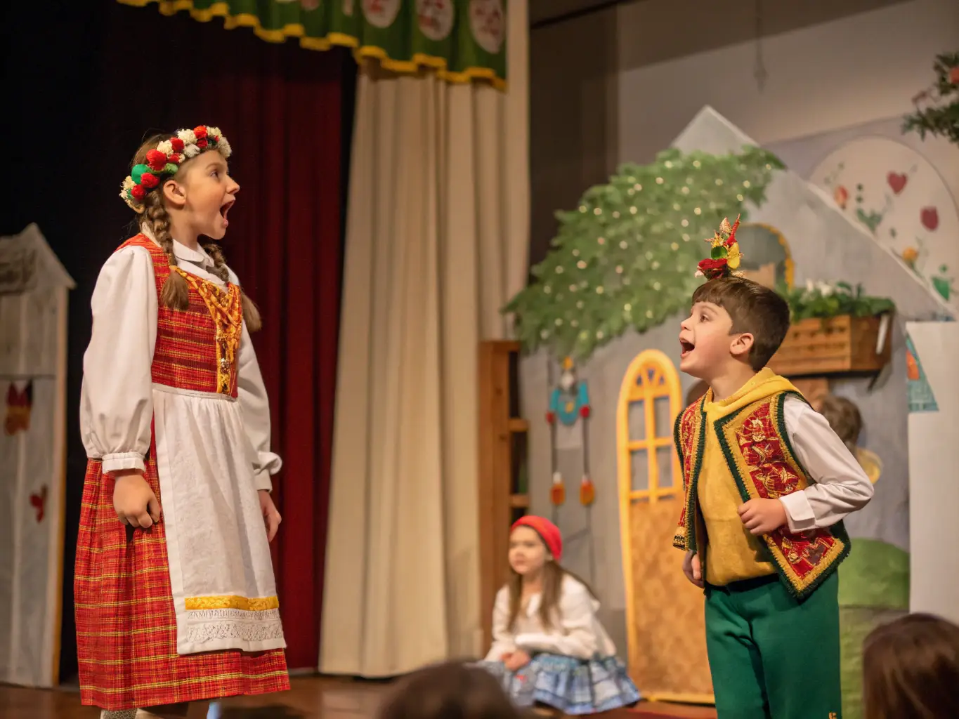 A group of children participating in a drama workshop, acting out a scene on a small stage with simple props and costumes.